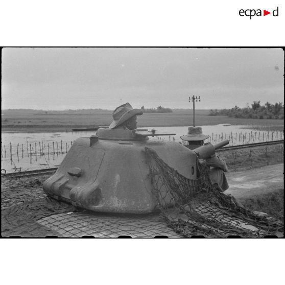 Soldats installés dans la tourelle d'un char située au-dessus du blockhaus.