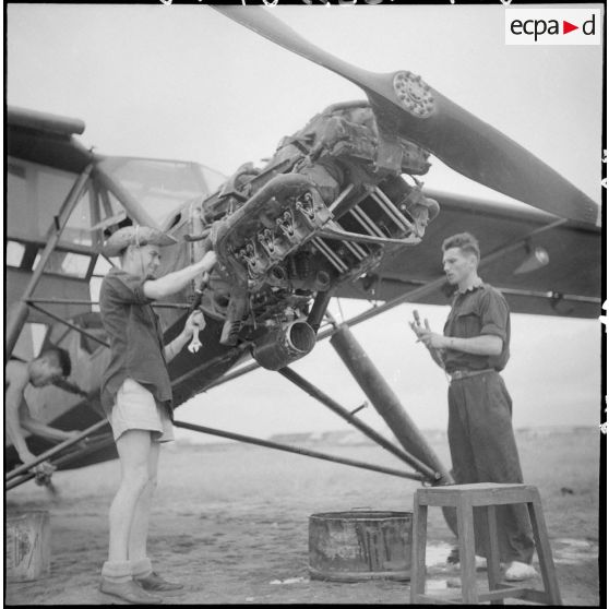 Révision du moteur d'un avion Morane-Saulnier avant le départ en mission du groupe d'aviation d'observation d'artillerie (GAOA) dans le delta du Tonkin.