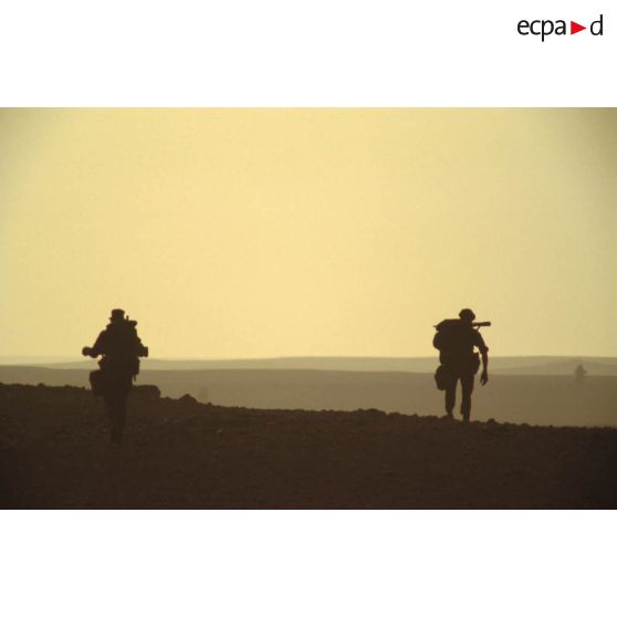 Deux militaires d'un groupe de combat du 1er RI marchent pour rejoindre un lieu d'héliportage par les appareils du 1er RHC (régiment d'hélicoptères de combat).
