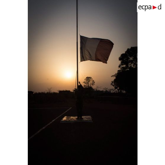 Tirailleur du GTIA (groupement tactique interarmes) Turco abaissant le drapeau lors de la cérémonie aux couleurs sur la place d'armes de la POD (plateforme opérationnelle défense) de Bambari, au soir du 13 mars 2015.