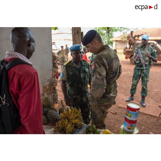 Le colonel Marc Espitalier, chef de corps du 1er RT et commandant le GTIA (groupement tactique interarmes) Turco converse avec un lieutenant-colonel congolais des casques bleus de la MINUSCA (mission multidimensionnelle intégrée des Nations Unis pour la stabilisation en Centrafrique) au marché de Bambari, dans le cadre de la réouverture des bureaux douaniers de la ville et l'installation de l'ORCCPA (office de réglementation, de commercialisation et de conditionnement des produits agricoles).