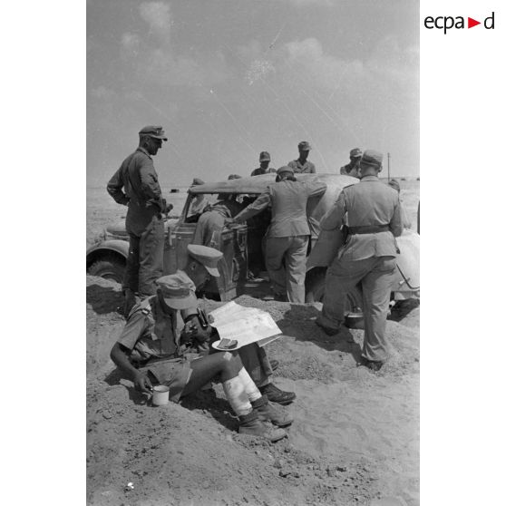 Des officiers de l'état-major du DAK allemand autour d'une voiture Horch Commandeur.