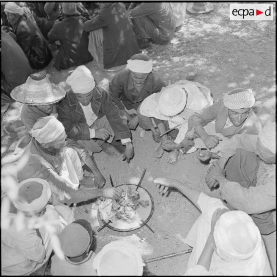 Les habitants de N'Daoud rassemblés autour des plats de couscous.