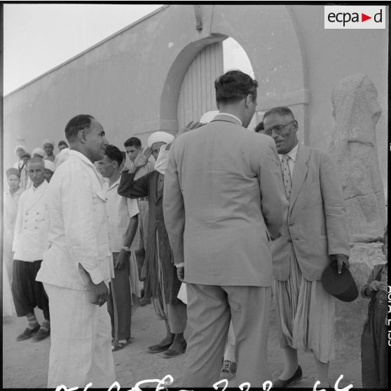 Le ministre parle avec l'instituteur et les élèves du village de Négrine.