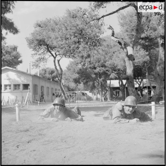 Au camp du Lido à Hussein Dey, deux appelés effectuent le parcours du combattant.