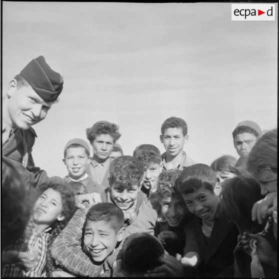 Un officier de la compagnie de haut-parleurs et de tracts (CHPT) avec des enfants de Guelma dans le cadre de l'action psychologique.