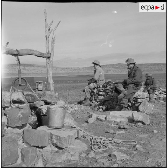 Des soldats du 9e régiment de tirailleurs algériens (BTA) surveillent le bon déroulement des semailles sur un champ près d'Aumale (actuelle wilaya de Médéa).