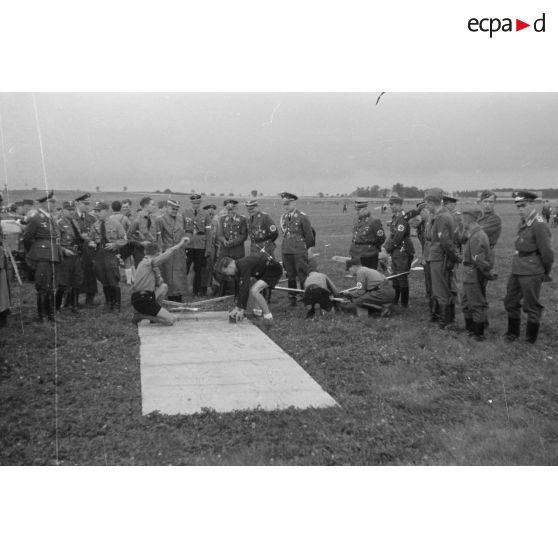 Un foule composée de civils, de membres de la Luftwaffe et du N.S.F.K. assistent au décollage et aux évolutions des modèles réduits lancés par des membres de la Hitlerjugend.