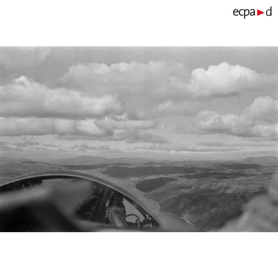 Survol d'un cours d'eau dans un paysage montagneux de Finlande par un avion allemand, sans-doute un Junkers W 34.