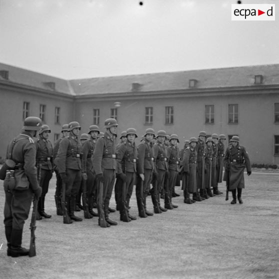 Des aviateurs allemands effectuent des exercices d'ordre serré, casqués et l'arme au pied.