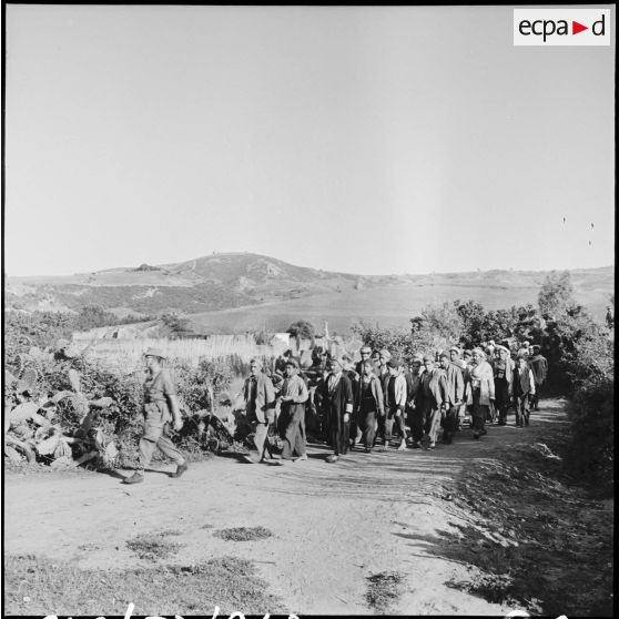 Rassemblement de villageois par des soldats dans le secteur de Thenia.
