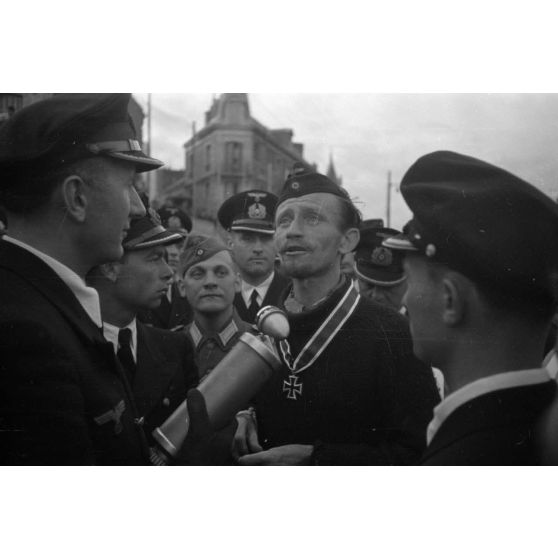 Le reporter (Rundfunkberichter) Heinrich Schwich réalise une interview du capitaine de corvette (Korvettenkapitän) Karl Thurmann, commandant du sous-marin U-553.