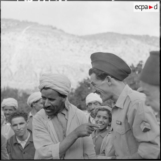 Deux parents, l'un garde du 3ème groupe mobile de protection rurale (GMPR) et l'autre paysan, se racontent les derniers potins du village.