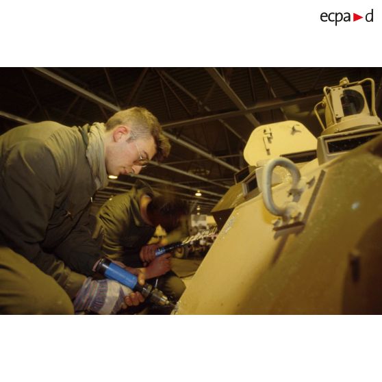 Des soldats du détachement matériel du GSL (groupement de soutien logistique) réalisent le surblindage d'un blindé de reconnaissance AMX-10 RC dans les environs de CRK (camp du roi Khaled).