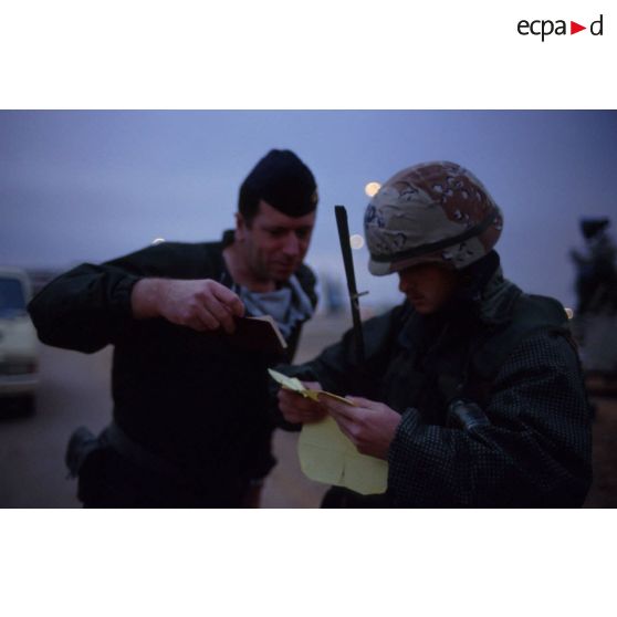 Un soldat américain contrôle l'identité d'un soldat français à l'entrée de la base air américaine de CRK (camp du roi Khaled).