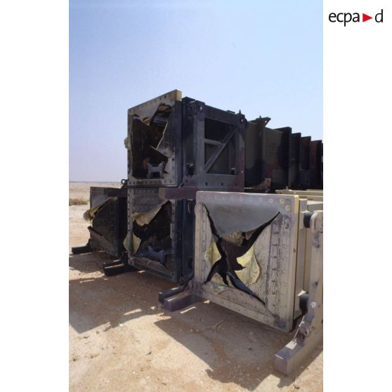 Containers de missiles anti-SCUD MIM-104 Patriot utilisés et posés sur le sable.