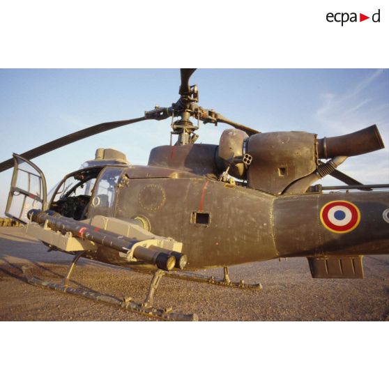 Au soir un hélicoptère de combat Gazelle Atam armé de missiles Mistral au sol dans le désert.