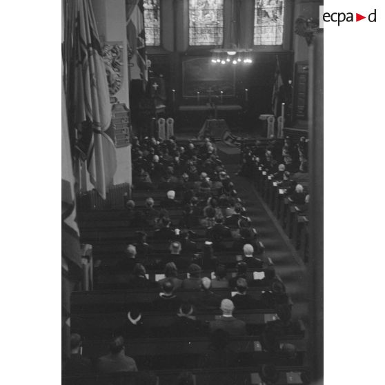 Une messe commémorative pour les marins allemands disparus lors de la Première Guerre mondiale, sur les murs de l'église les emblèmes rendent hommage aux navires allemands.