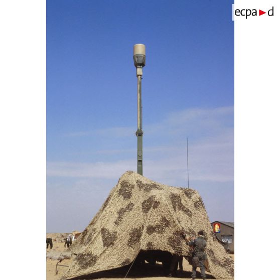 La station sol Mistigri de réception Orchidée (observatoire radar cohérent héliporté d'investigation des éléments ennemis) camouflée par un filet.