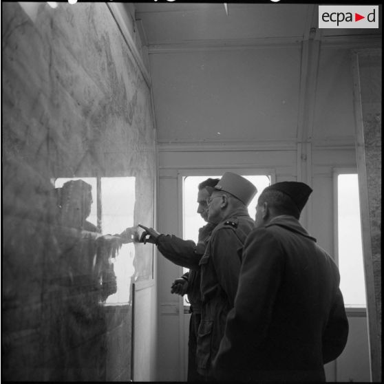 Le général Divary observe une carte dans la salle de briefing de l'aviation de la base aérienne de Tebessa.