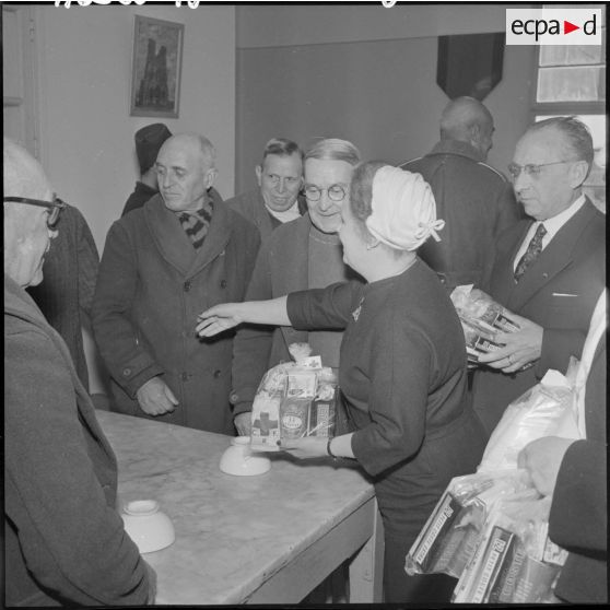 Madame Lacoste, épouse du ministre de l'Algérie, distribue des friandises au centre des invalides de Kouba.