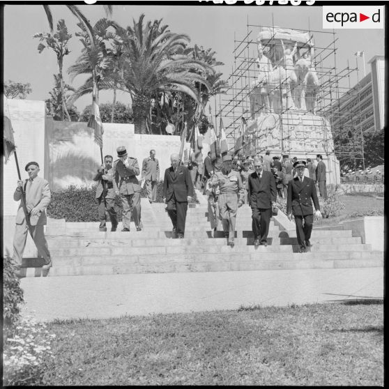 Le général Raoul Salan quitte le monument et passe sous les drapeaux de la Légion. Ceux-ci sont présentés par des anciens de cette arme.