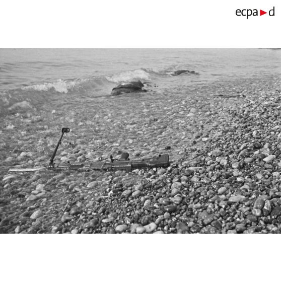 Un fusil-mitrailleur Bren et deux cadavres sur la plage de Dieppe après le raid canadien (Opération Jubilee) du 19 août 1942.