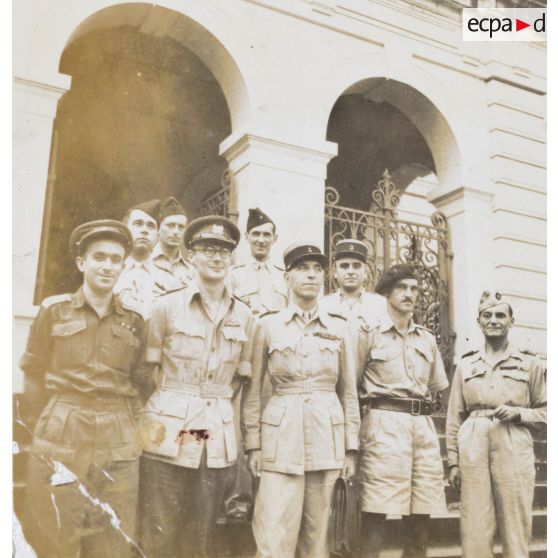 Devant le palais de justice, le lieutenant colonel Sompeyrac, président du tribunal militaire permanent de Saigon (au milieu) et le personnel de la cession du 23-12-46. [description provisoire]