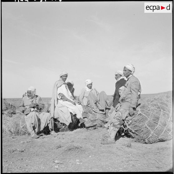 La Fontaine. Les nomades se reposent assis sur les ballots d'alfa.