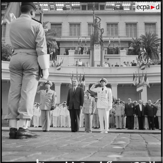 Alger. Commémoration de l'anniversaire de l'appel du 18 Juin 1940. Paul Delouvrier, le général Challe, l'amiral Aboyneau, saluent le drapeau.