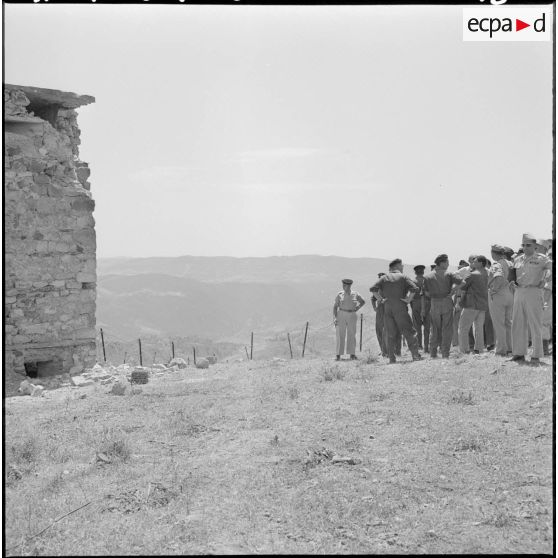 Les journalistes en visite au poste d'Aïn-Zana face à la tour de la Section administrative spécialisée (SAS) en partie détruite.