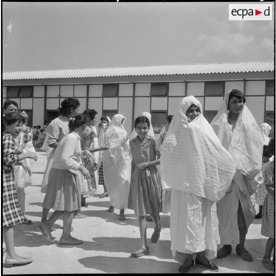 Les jeunes filles de l'école professionnelle de Miliana se rassemblent, accompagnées de leurs mères, pour leur sortie en autocar en direction du port d'Alger.