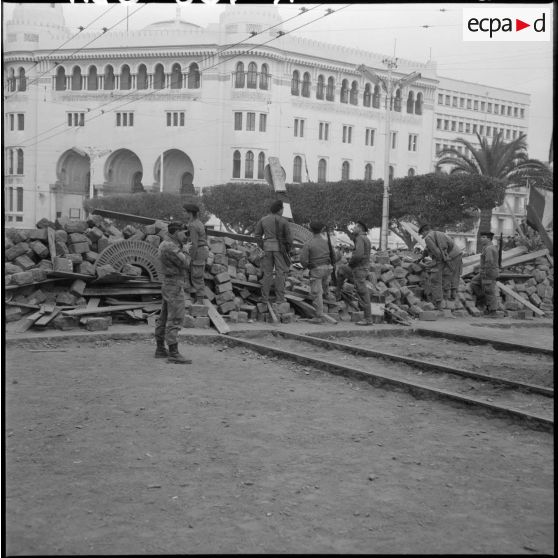  Un reporter opérant derrière les barricades du secteur de la Grande Poste, rue Charles Péguy