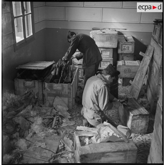 Ouverture de plusieurs caisses d'armes. [Description en cours]