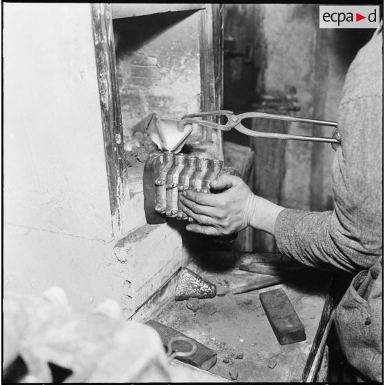 Constantine. Artisan bijoutier coulant de l'or dans un moule.