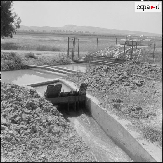 Vue d'une vanne et d'un canal d'irrigation.