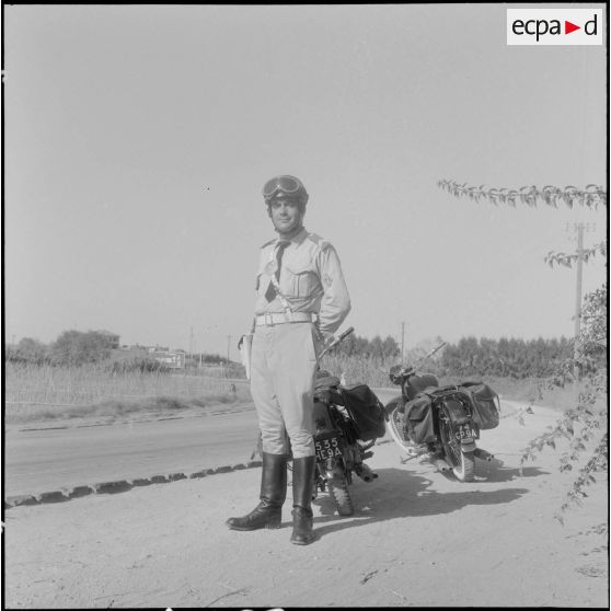 Pendant que l'un des policiers contrôle un véhicule, l'autre surveille la circulation.