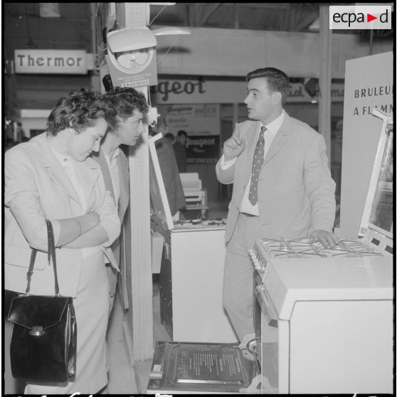 Alger. Exposition d'électroménager. Un jeune couple s'intéresse vivement à un modèle de four-cuisinière.