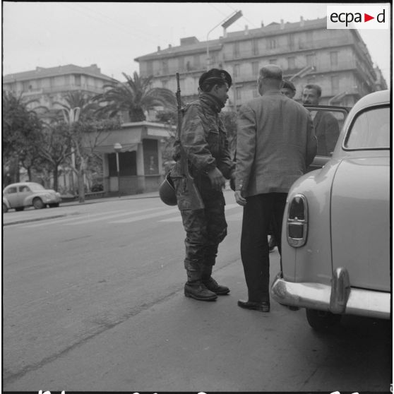 Alger. Grève générale à l'appel de l'Organisation armée secrète (OAS). Une patrouille fouille deux hommes en voiture.