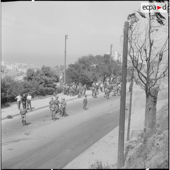 Alger. Quartier des Tagarins. Explosion d'un camion-citerne. Des soldats et des civils dans une rue.