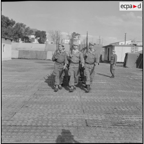 Section d'élèves gradés en cours d'ordre serré et maniement d'armes, au 1er bataillon du 26ème régiment d'infanterie (RI) au camp des anglais.
