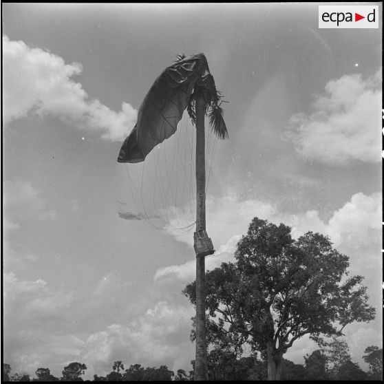 27 Le matériel et son parachute restés accrochés à un arbre. [description provisoire]