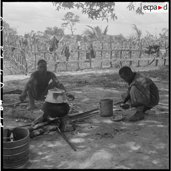 11 Préparation du repas par 2 hommes du 2/6e RIC (2e Bataillon du 6e Régiment d'Infanterie Coloniale). [description provisoire]