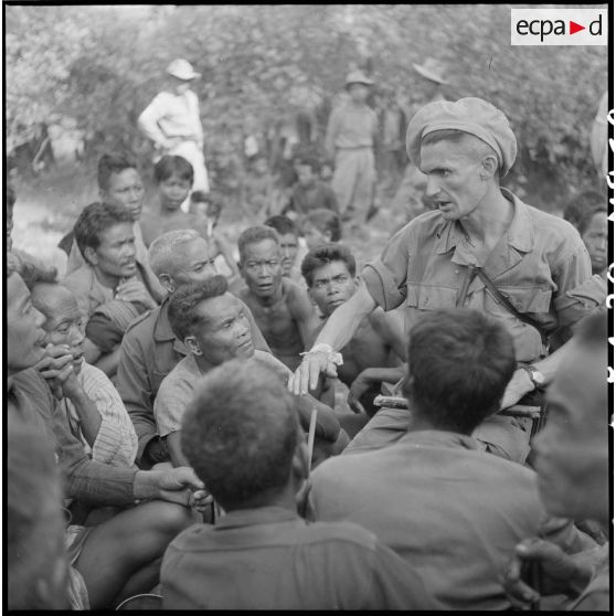 Le capitaine Grandjean du 2e bataillon de chasseurs laotiens (2e BCL) au milieu des Khas ralliés.