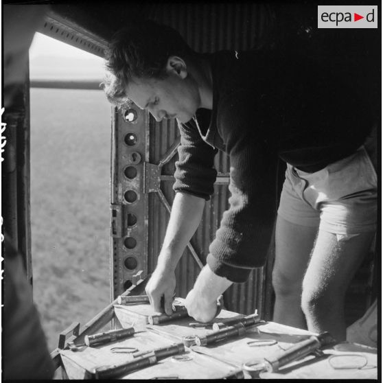 Amorçage des touques de napalm dans un bombardier en vol.