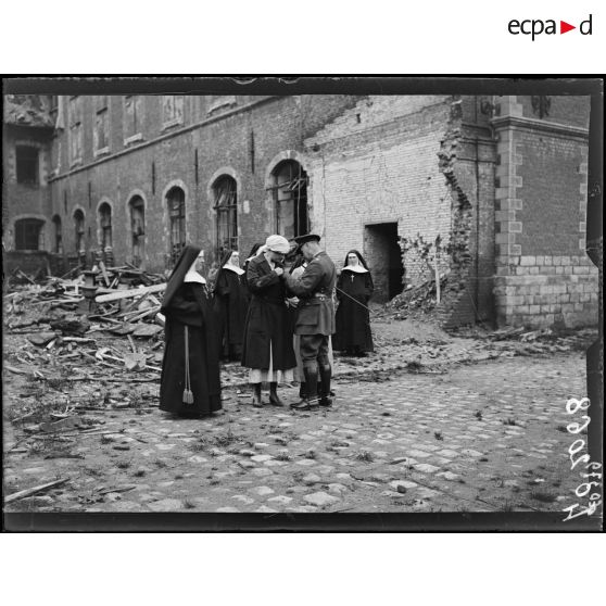 Hazebrouck, remise de la croix de guerre par le général de la Guiche à madame la duchesse de Sutherland, à madame Lionville et à une soeur de l'hôpital. Le général lit la citation. [légende d'origine]