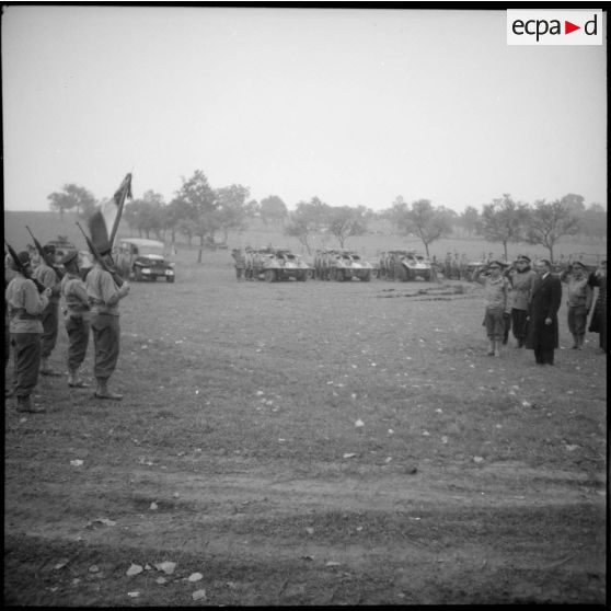 Lors d'une prise d'armes organisée dans le cadre de la visite au Régiment blindé de fusiliers marins (RBFM) de Louis Jacquinot, ministre de la Marine, les officiers présents saluent l'étendard de l'unité.
