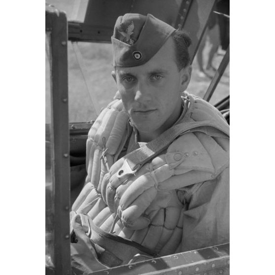Plan serré sur un pilote allemand aux commandes d'un chasseur Messerschmitt, verrière ouverte.