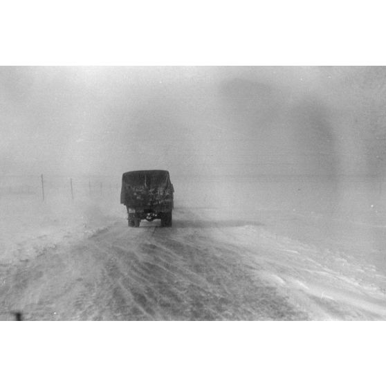 Dans une tempête de neige, la progression sur une route glacée.