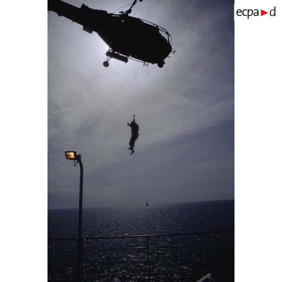 Hélicoptère Alouette-III de l'aéronavale en cours d'opération d'hélitreuillage d'un personnel sur le pont du ferry Corse navigant sur l'Adriatique.